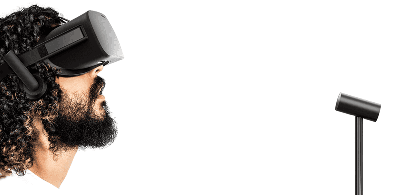 A man who has a beard and who also has a jaw, which is slack, uses the Oculus Rift as he is tracked by the Rift’s external sensor. (Photo: Oculus)
